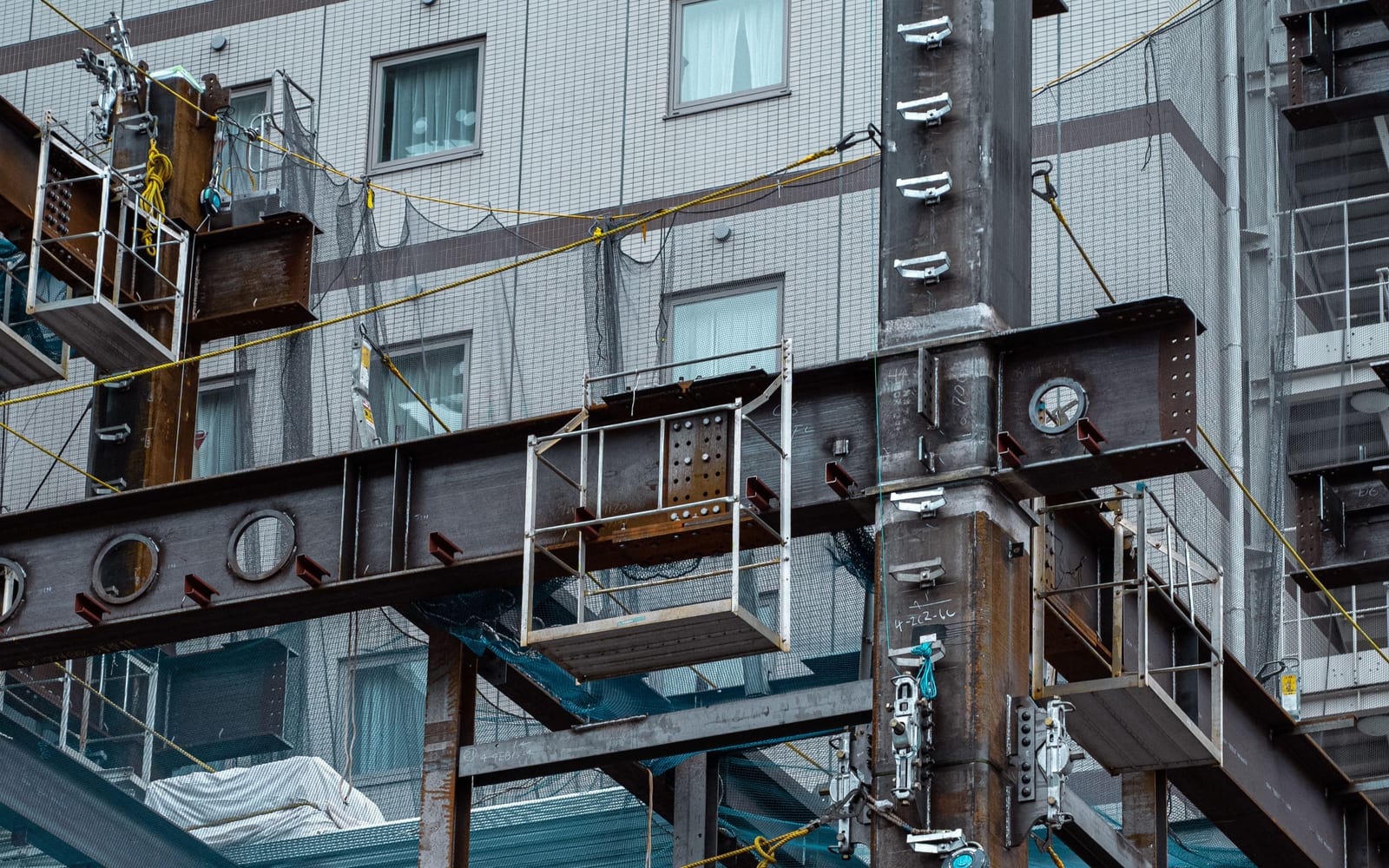A building mid-refurbishment, steel frame exposed while the structure stands