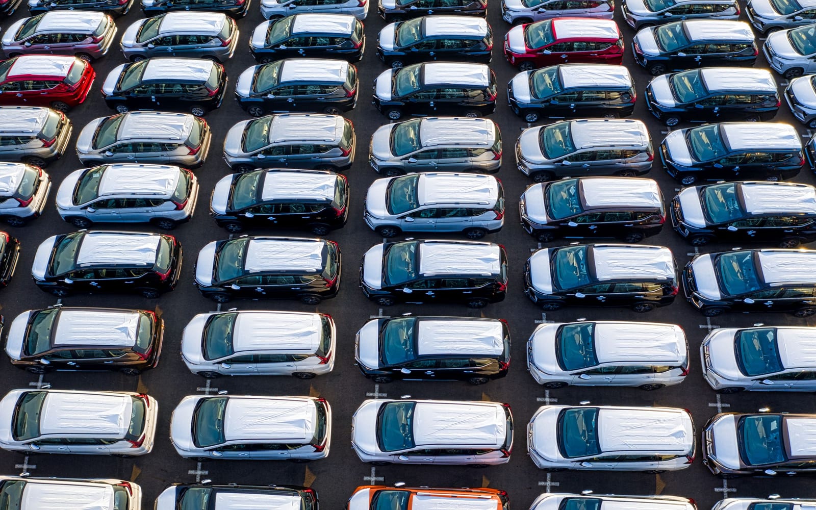 Stacks of pressed vehicle door frames, many variants of the same component