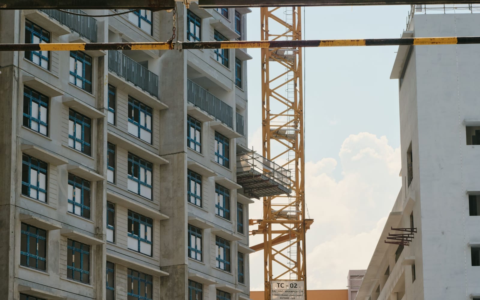 A half-finished concrete building with a crane still standing and work stopped
