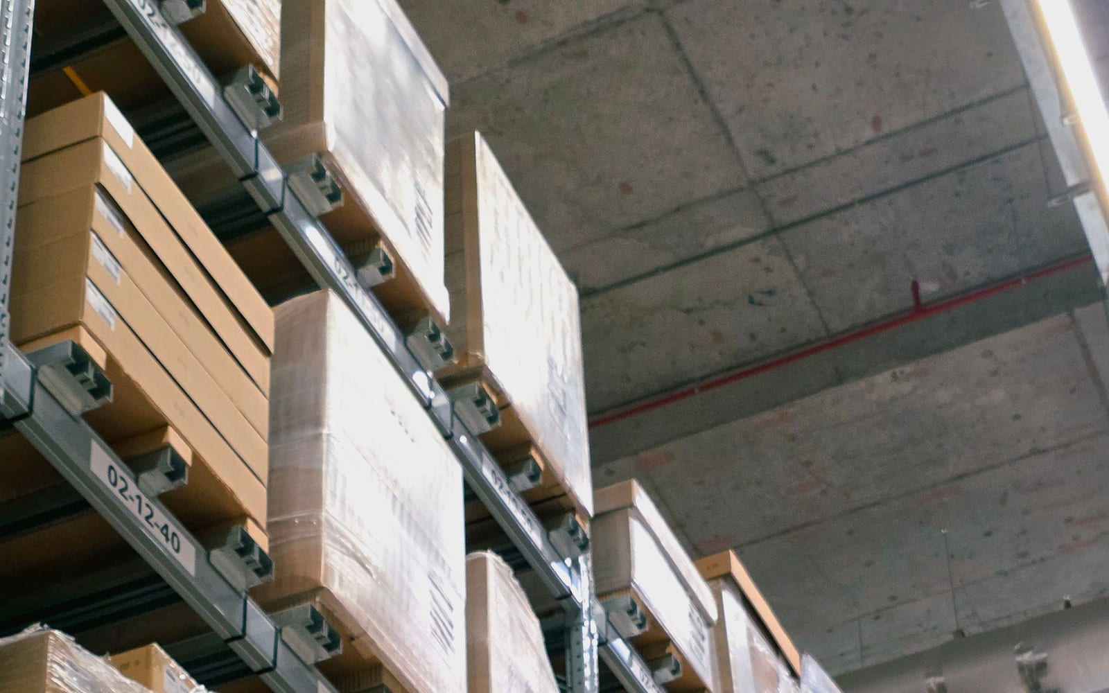 Warehouse pallet racking with numbered bay location labels on each shelf