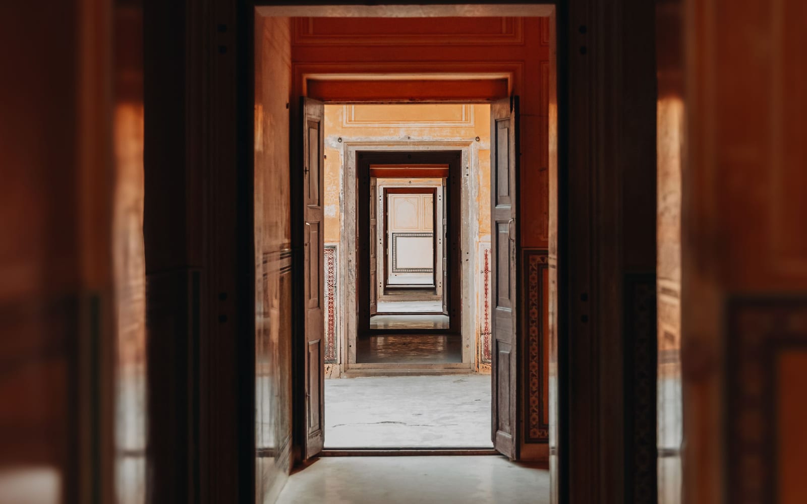 An enfilade of doorways receding, each one framing the next