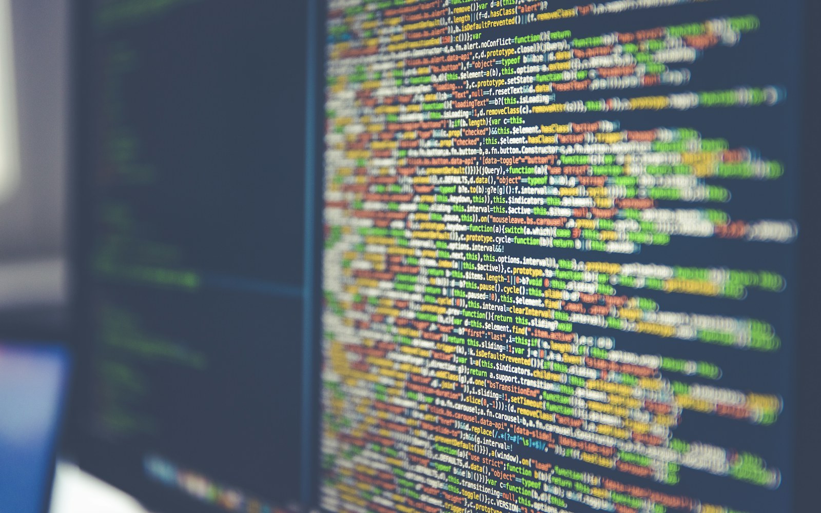 Syntax-highlighted source code filling a monitor