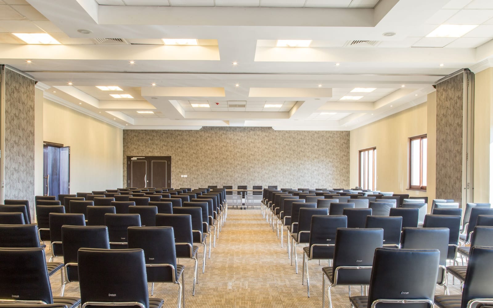 A large empty training room with rows of unused chairs