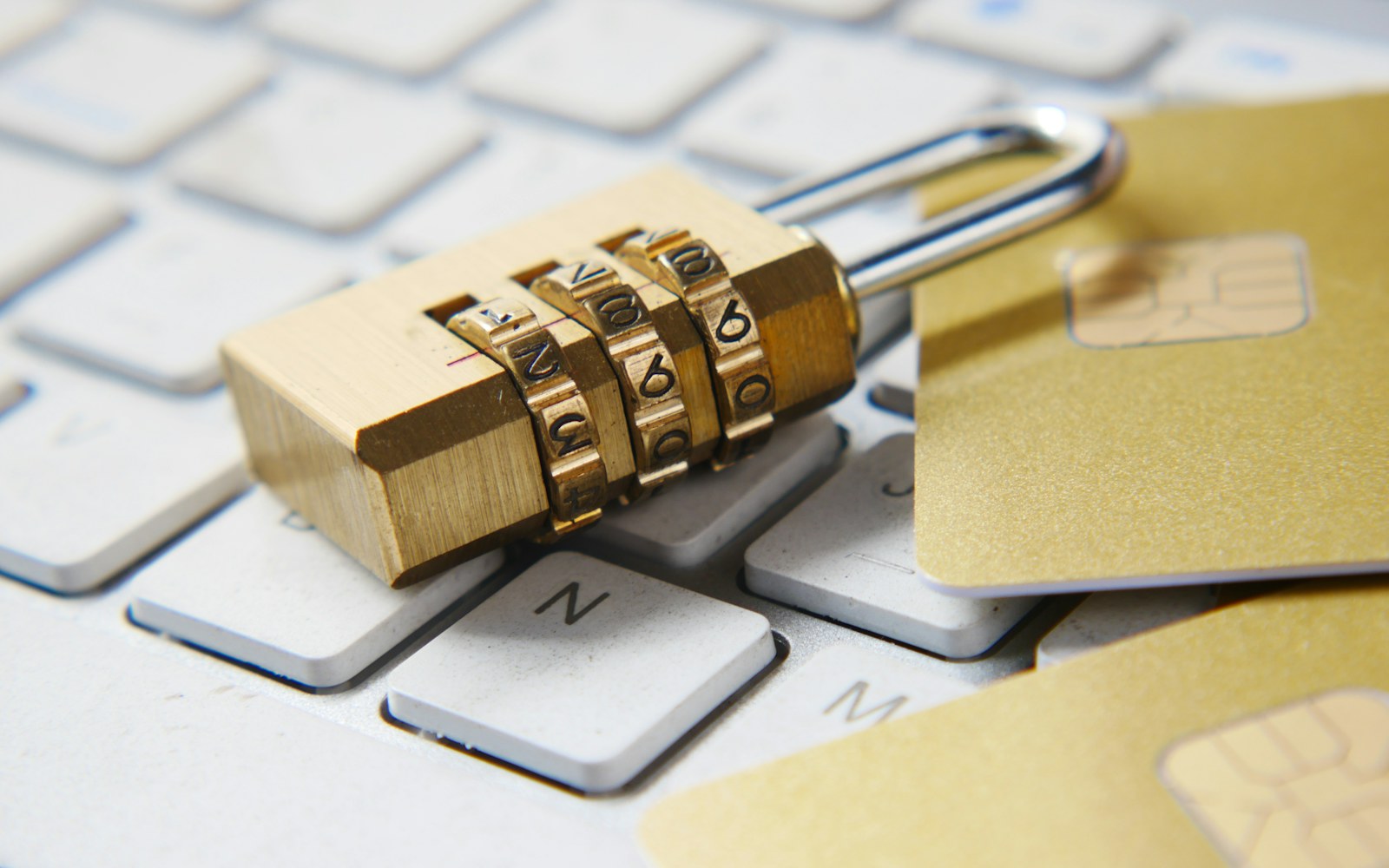 A combination padlock resting on a laptop keyboard