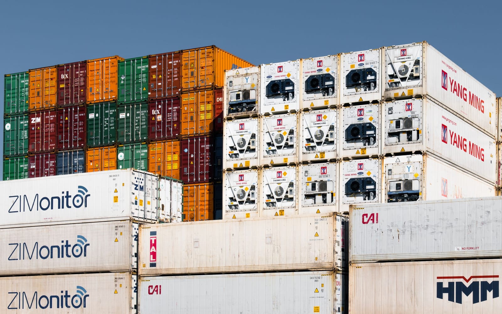 Stacked shipping containers arranged in colour-coded tiers