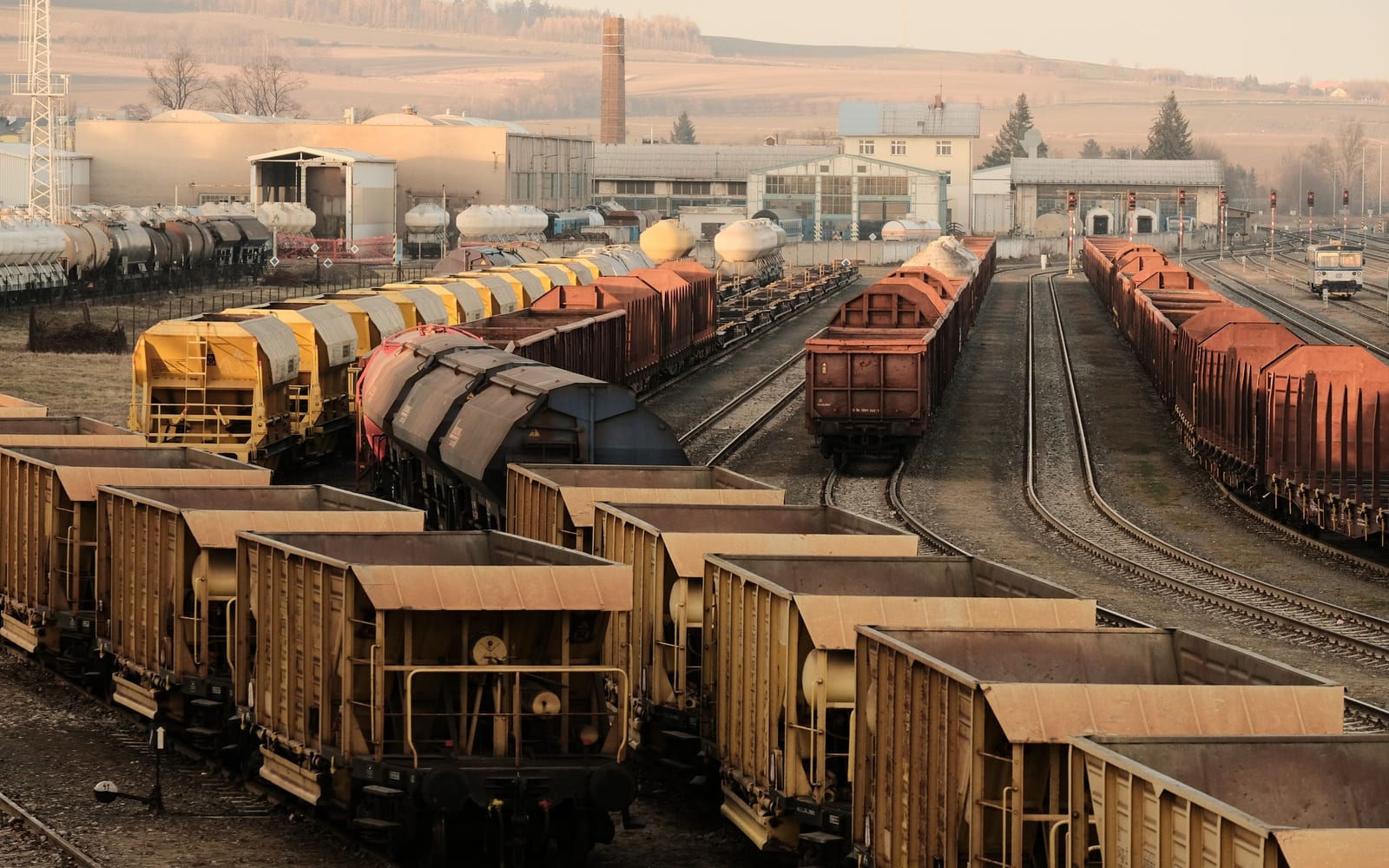 A railway marshalling yard with different types of freight wagon on parallel sidings