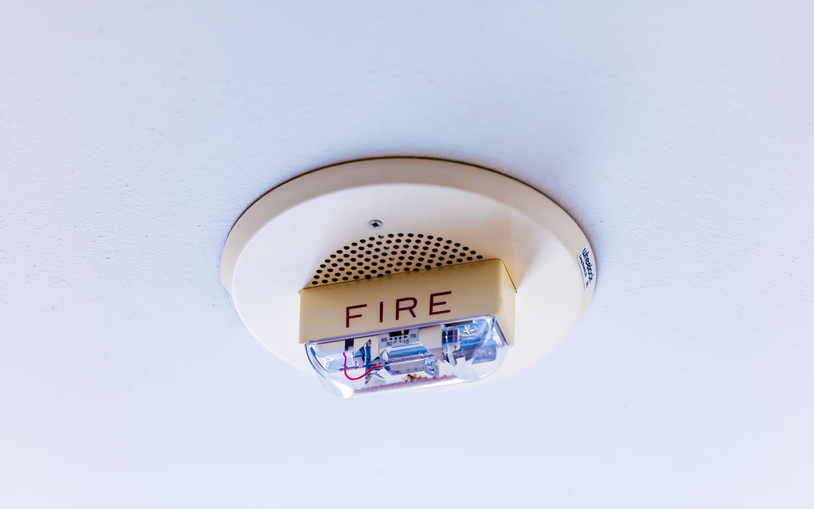 A ceiling-mounted fire alarm of the kind people stop noticing