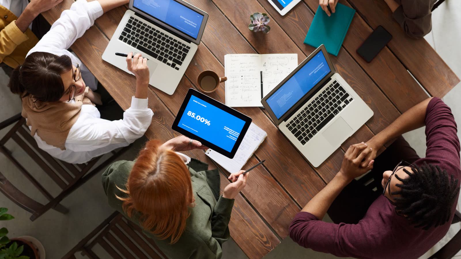 A technology team reviewing system configuration together at a shared workstation.