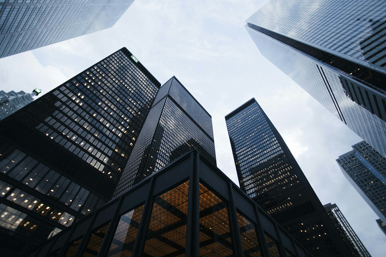 Glass office tower facade representing commercial services firms where CRM, PSA, and finance must share one contract language.
