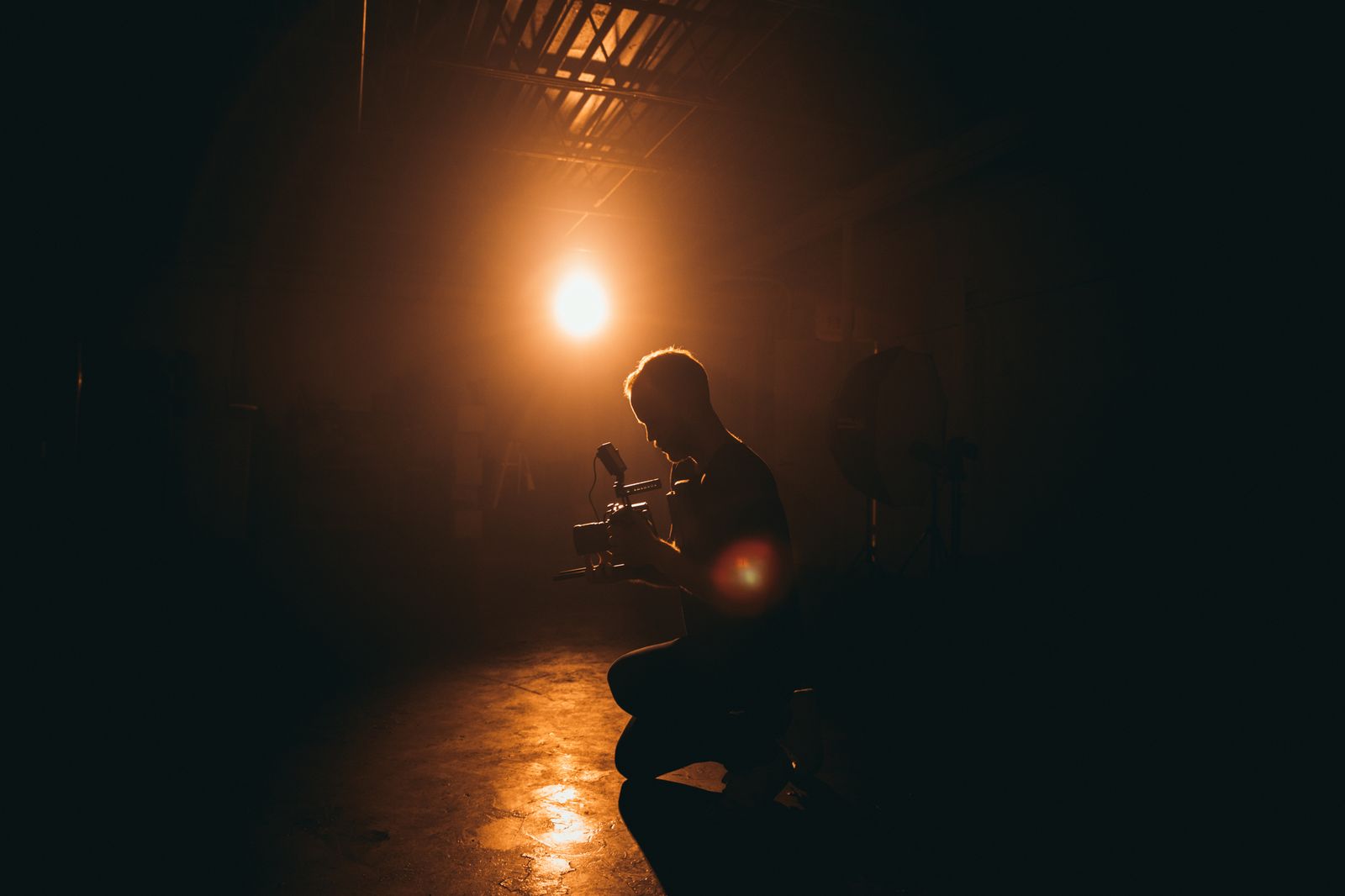 Media production crew with cinema camera under studio lighting, representing media operating rhythm.