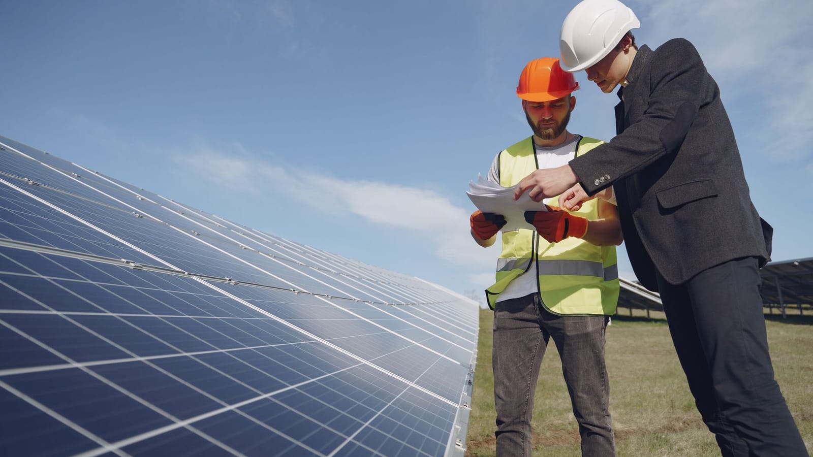 Two engineers inspecting equipment together on site.