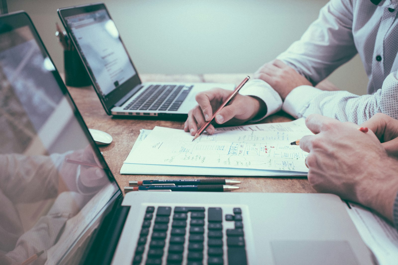 Finance operations workspace with analysts reviewing ledgers and controls, the operational pressure that must stay aligned with CRM and core boundaries.
