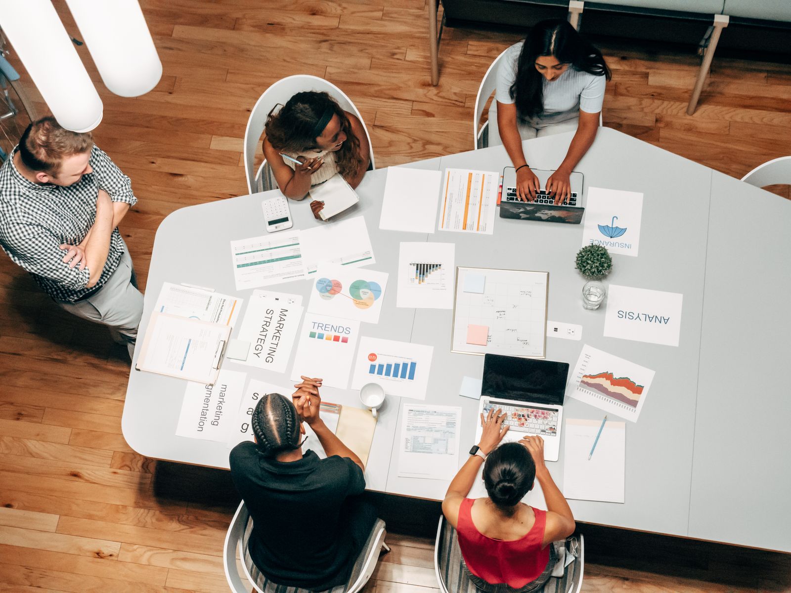 Advisory team reviewing insurance and wealth planning documents together, the household moment Financial Services Cloud must support on one spine.