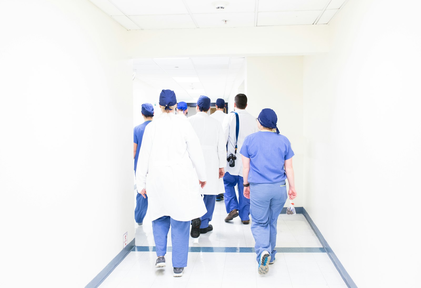 Clinical care team walking a hospital corridor, the coordinated access and program reality Health Cloud must support.
