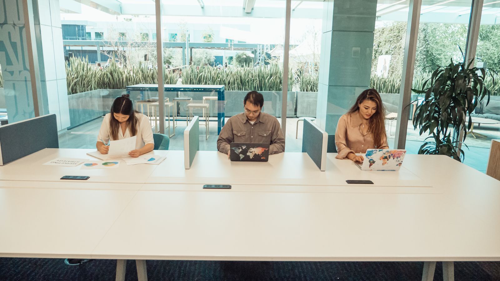 A cross-functional team gathered around one screen, working the problem together.