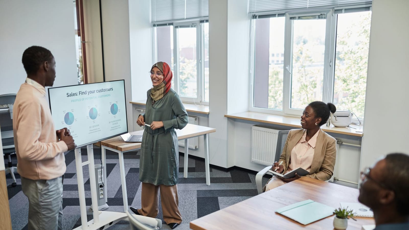 A facilitator running a training session for a small group of colleagues.