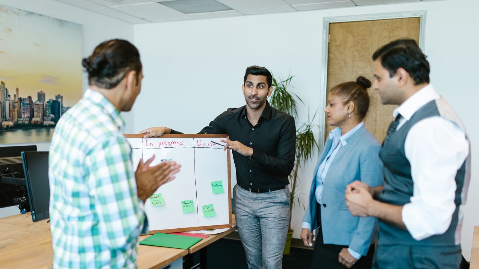 A sales team standing together in a working session.