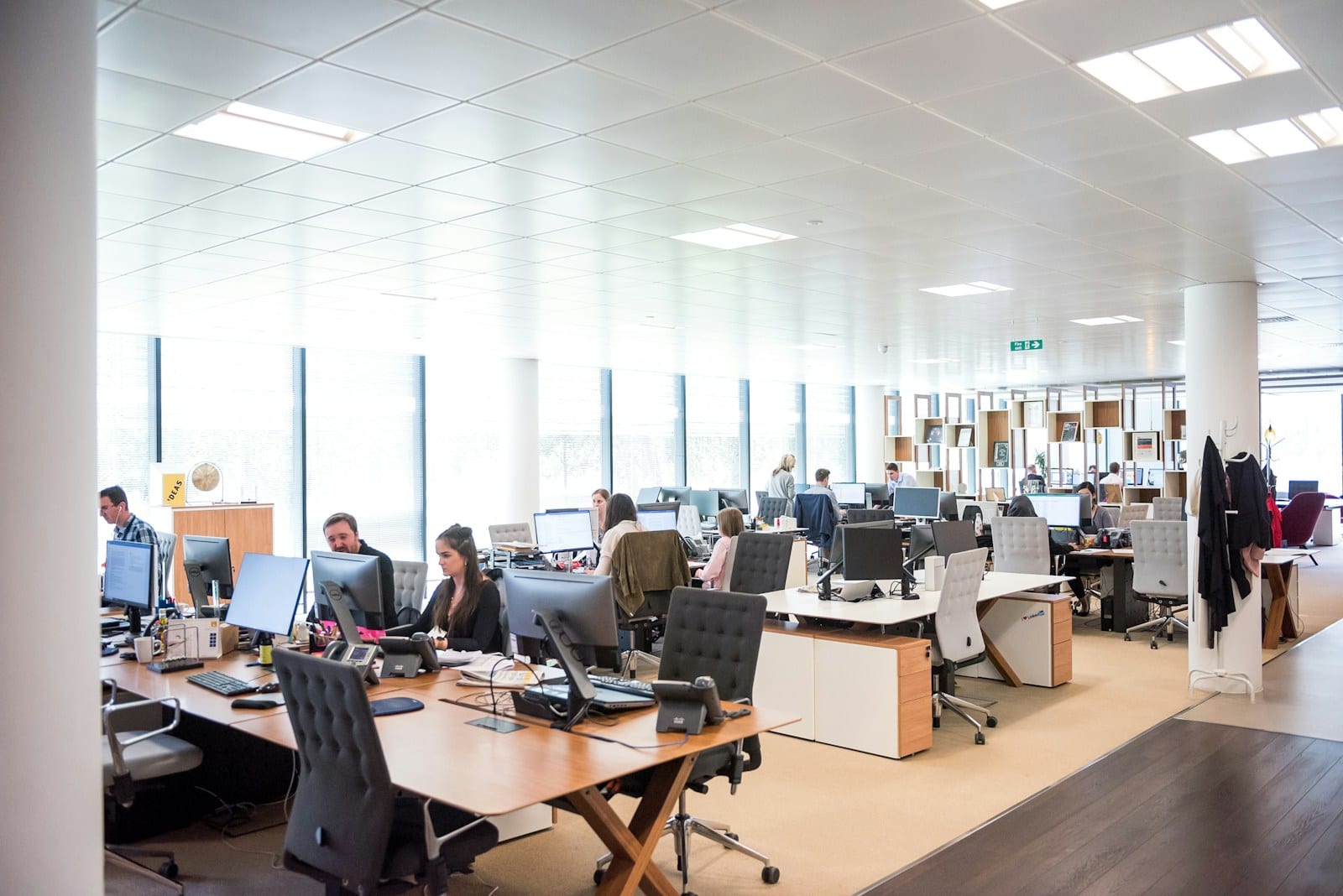 An open-plan enterprise floor where cross-functional teams work side by side.