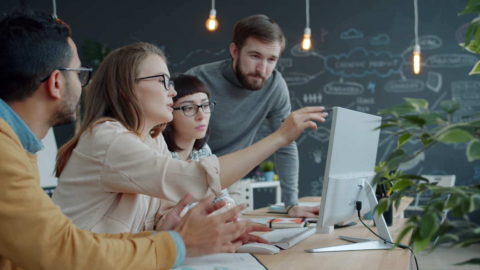 A cross-functional team gathered around one screen, working the problem together.