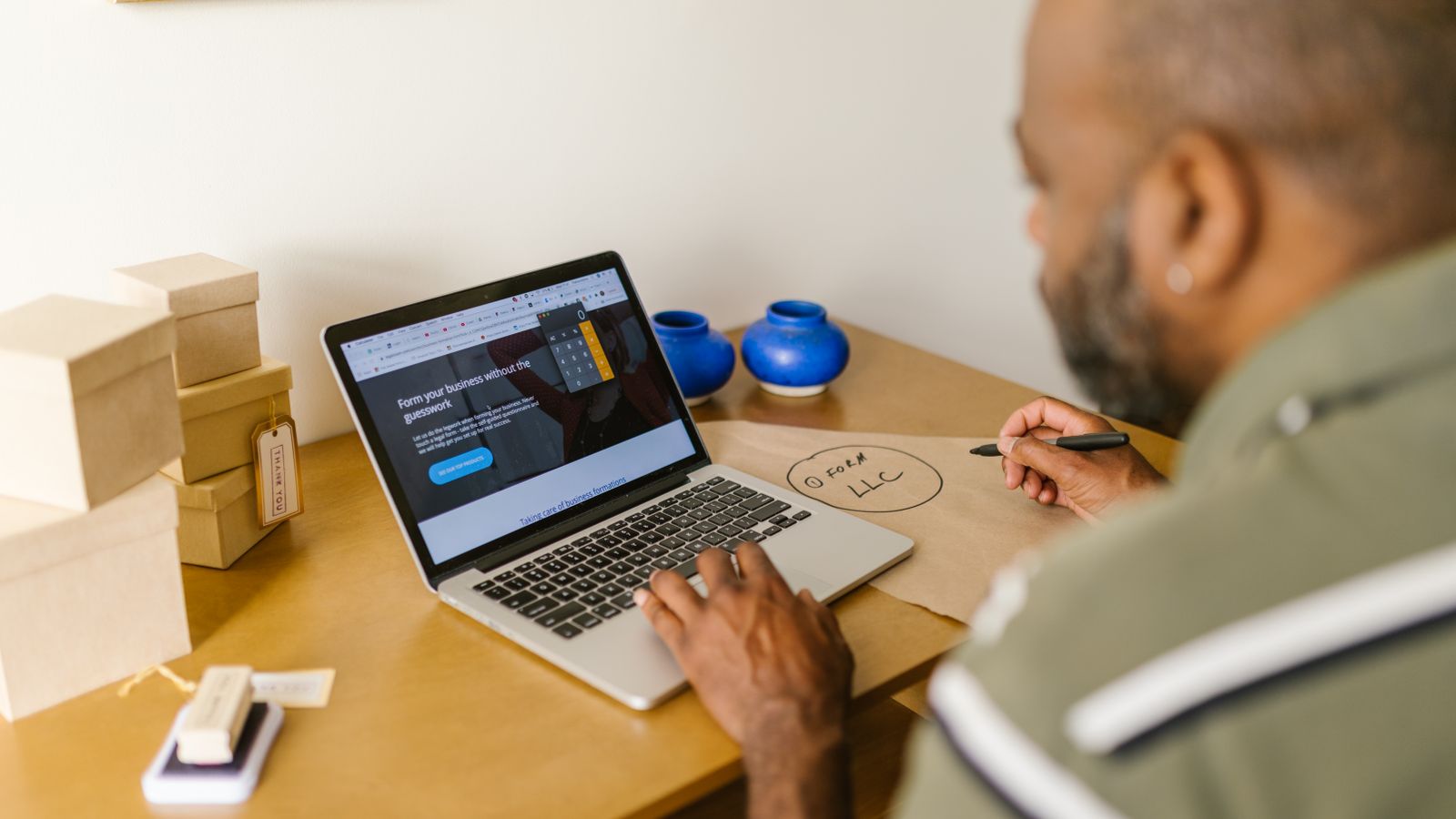 A small business owner working at a laptop.