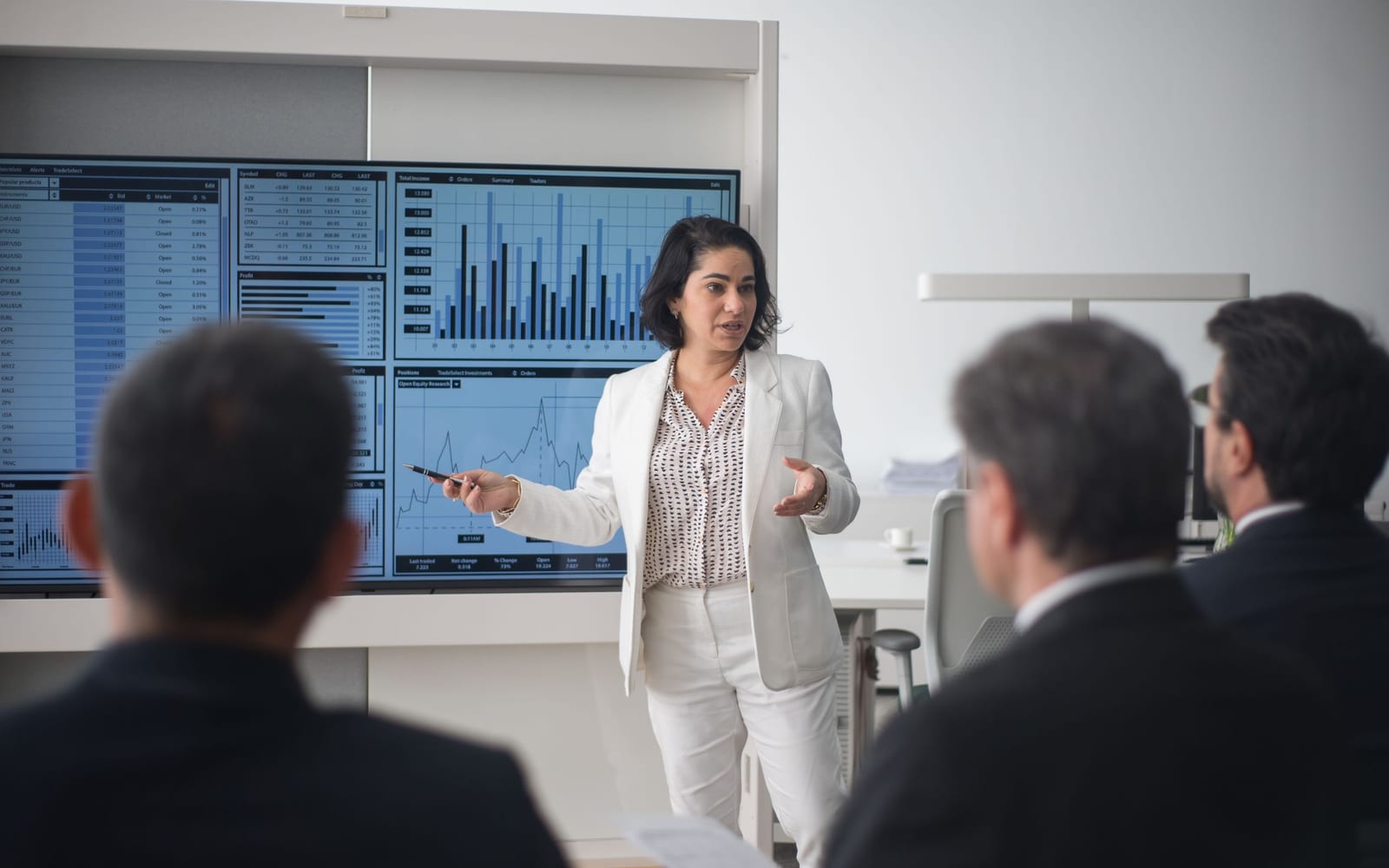 An enterprise meeting in a glass-walled conference room.