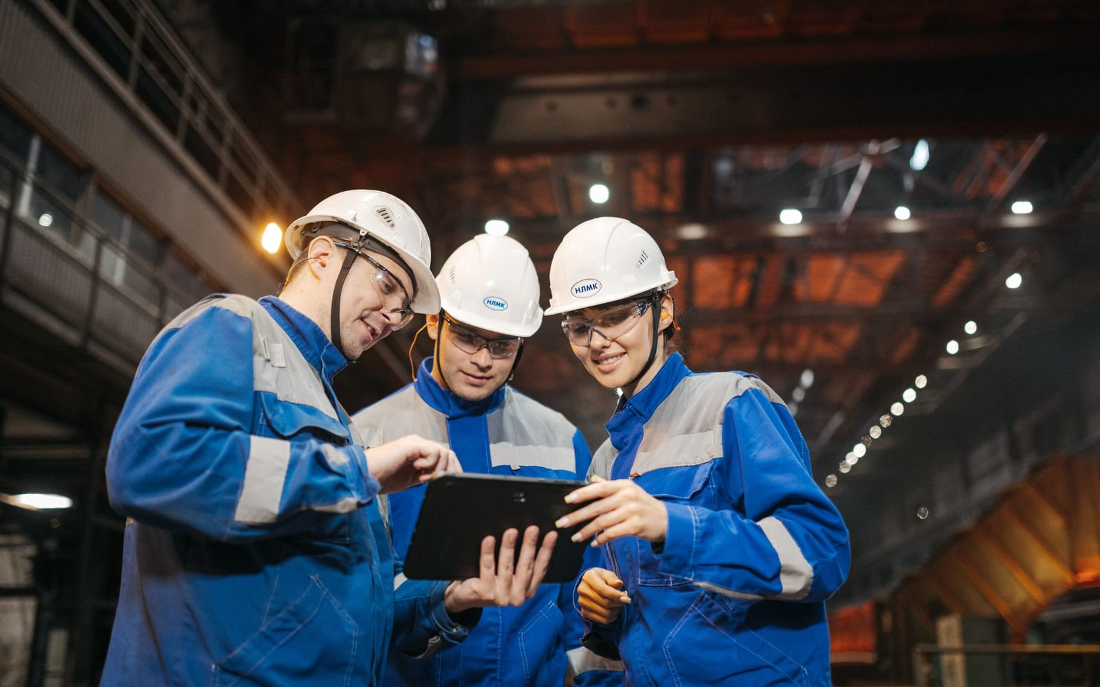 A technician using a tablet on a work site.