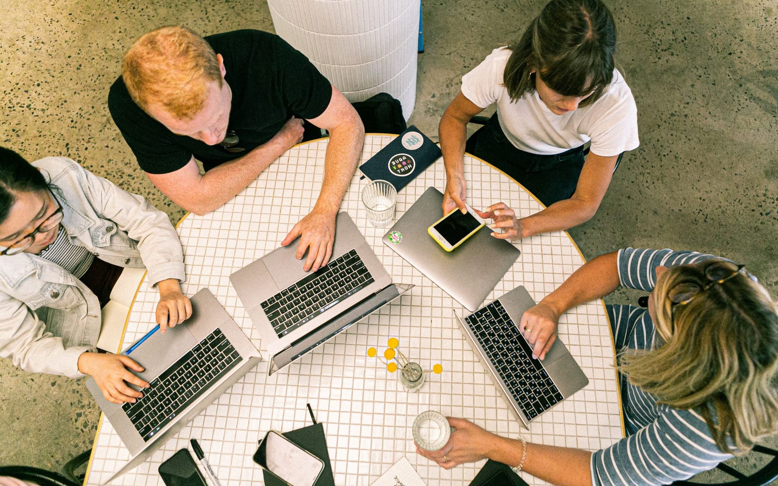 An enterprise meeting in a glass-walled conference room.