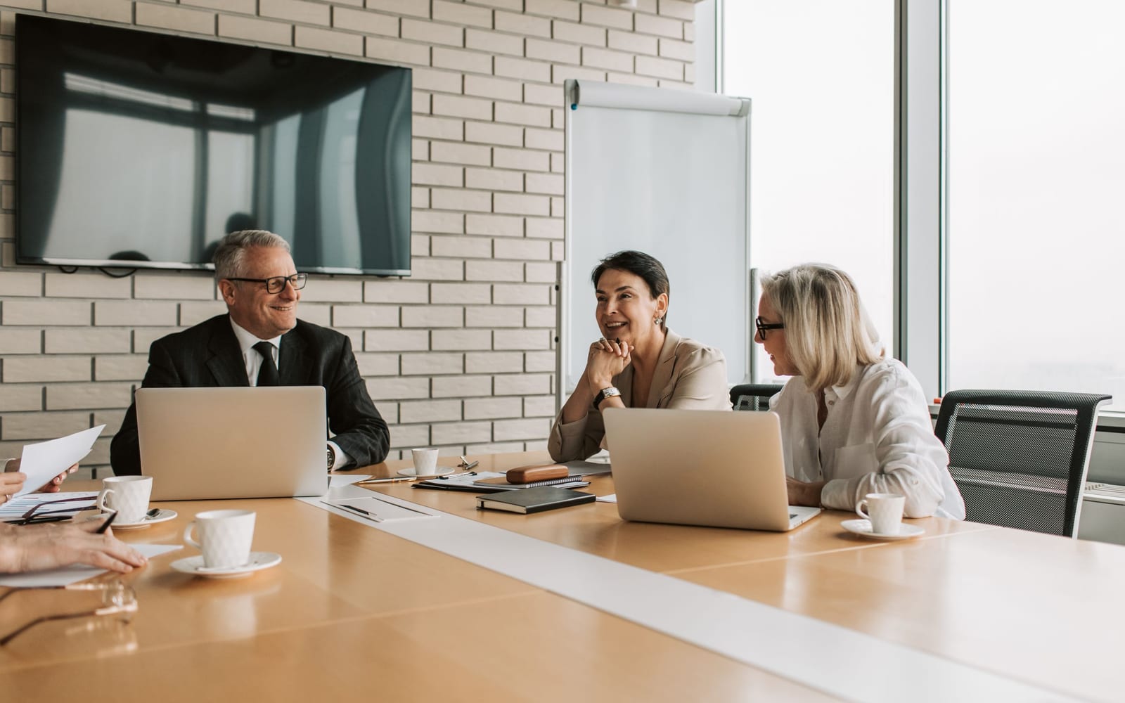 An enterprise meeting in a glass-walled conference room.