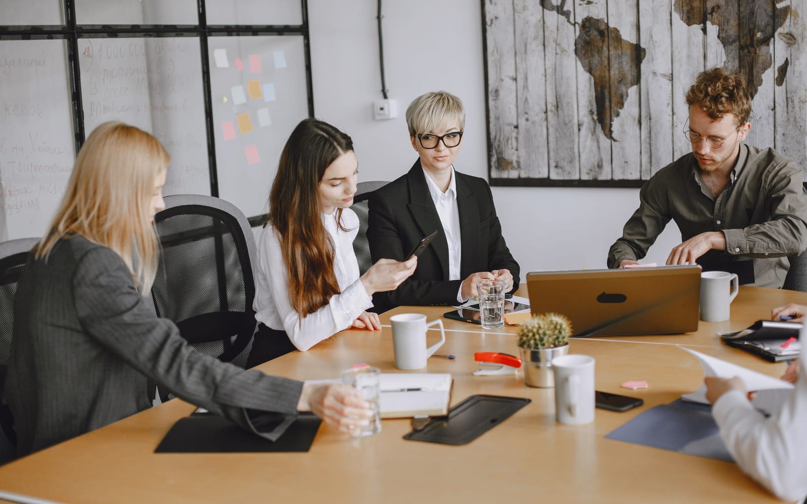 An enterprise meeting in a glass-walled conference room.