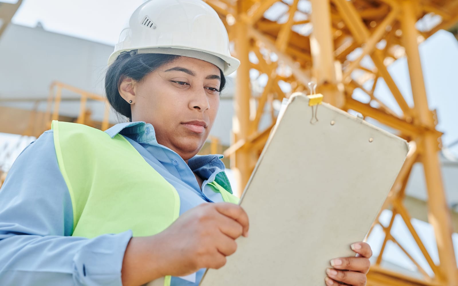 A technician using a tablet on a work site.