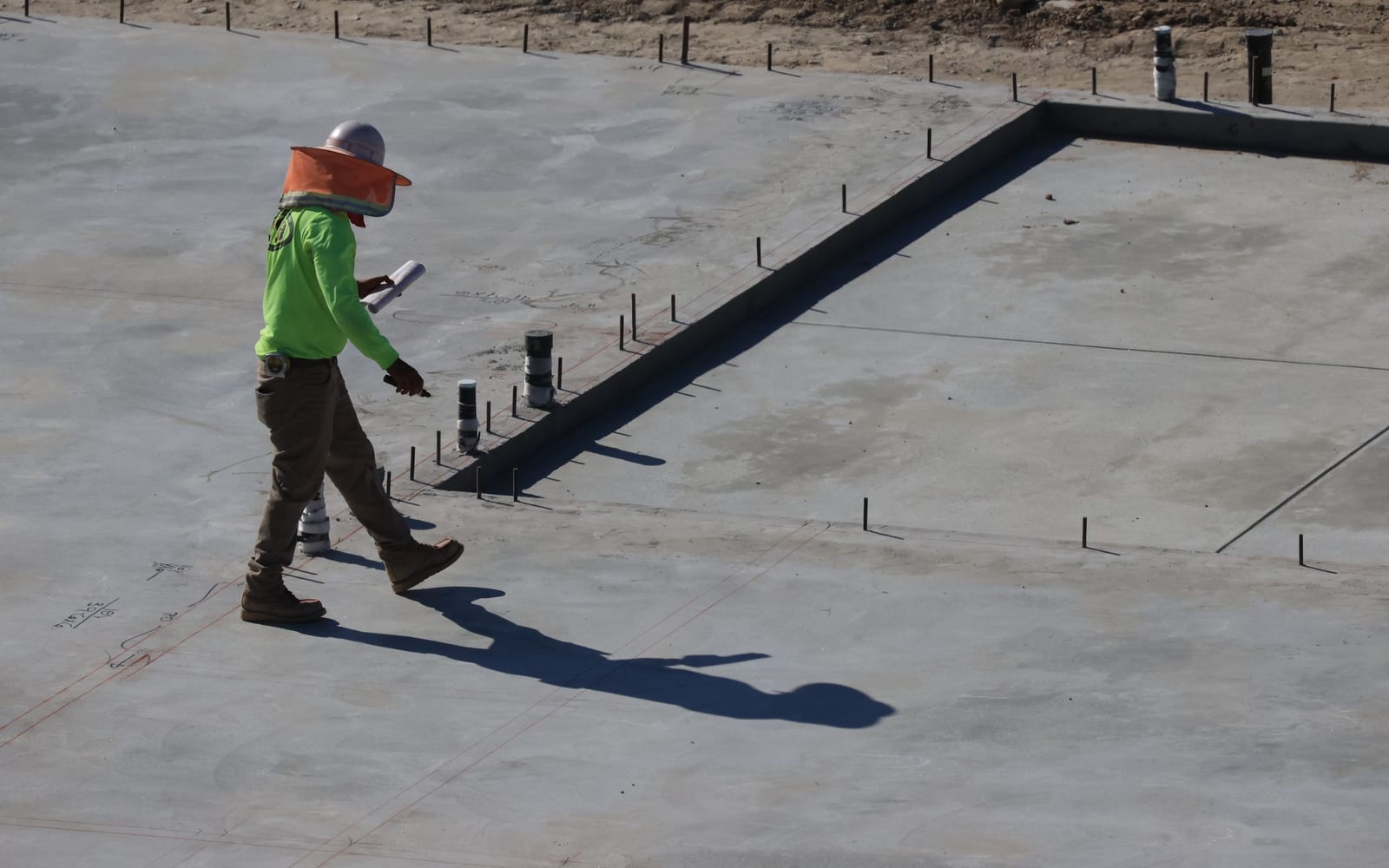 A technician using a tablet on a work site.