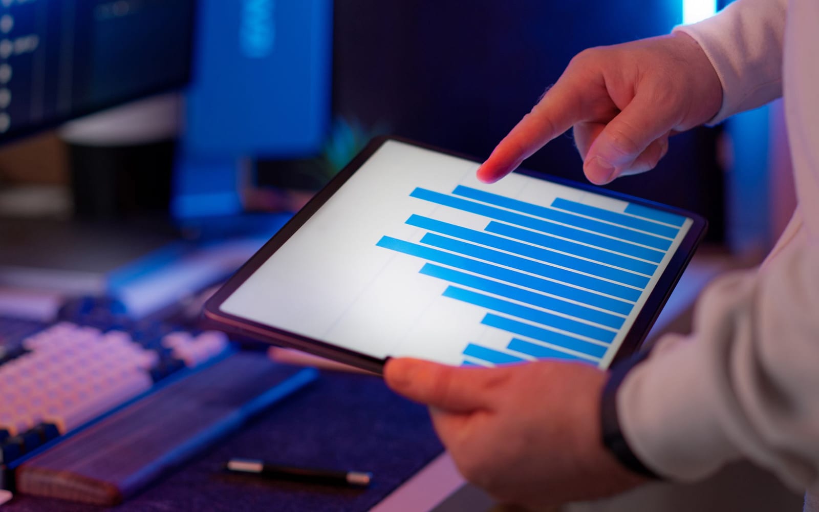 An analyst reviewing figures on a laptop in an office.