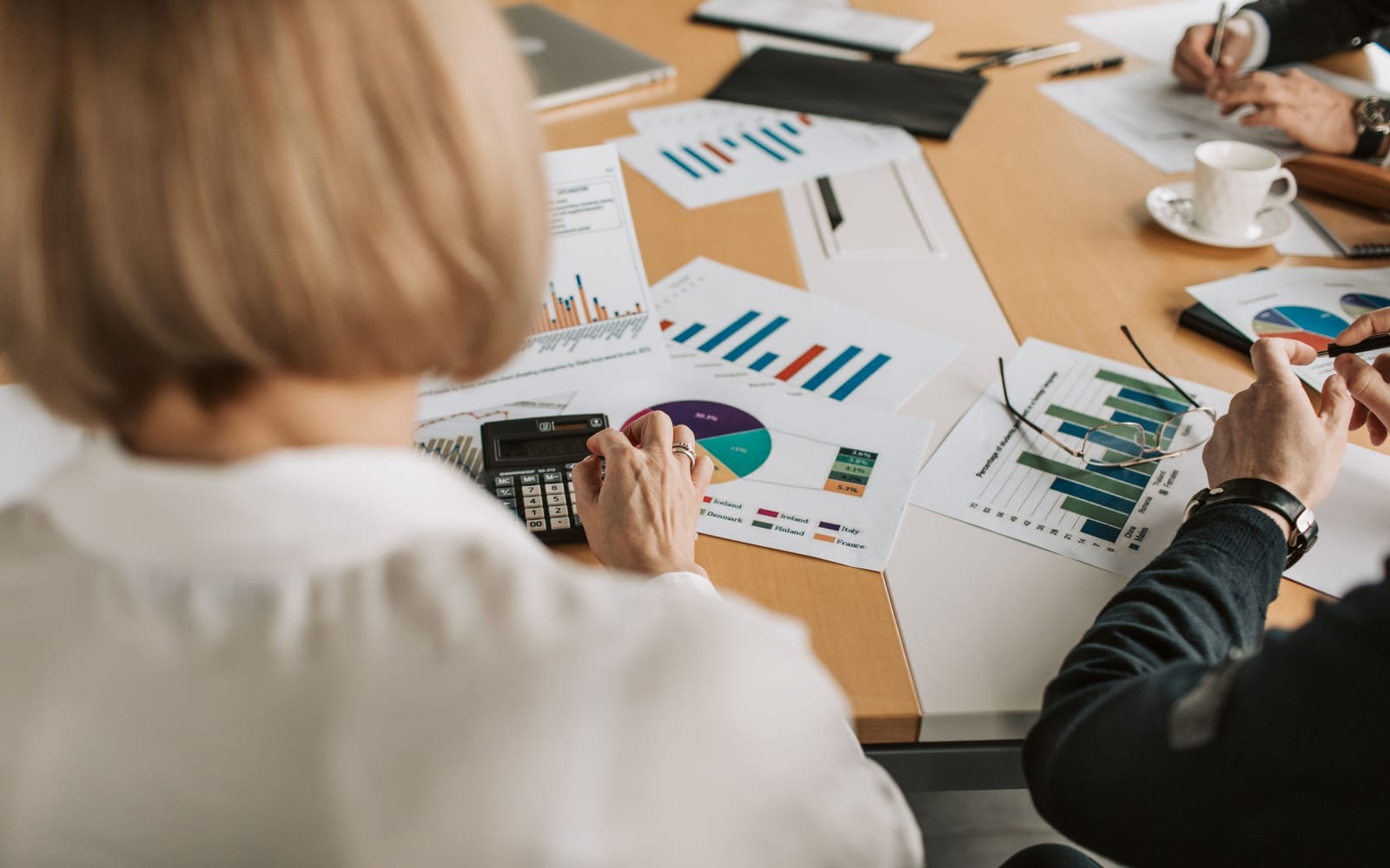 A finance meeting around a conference table.