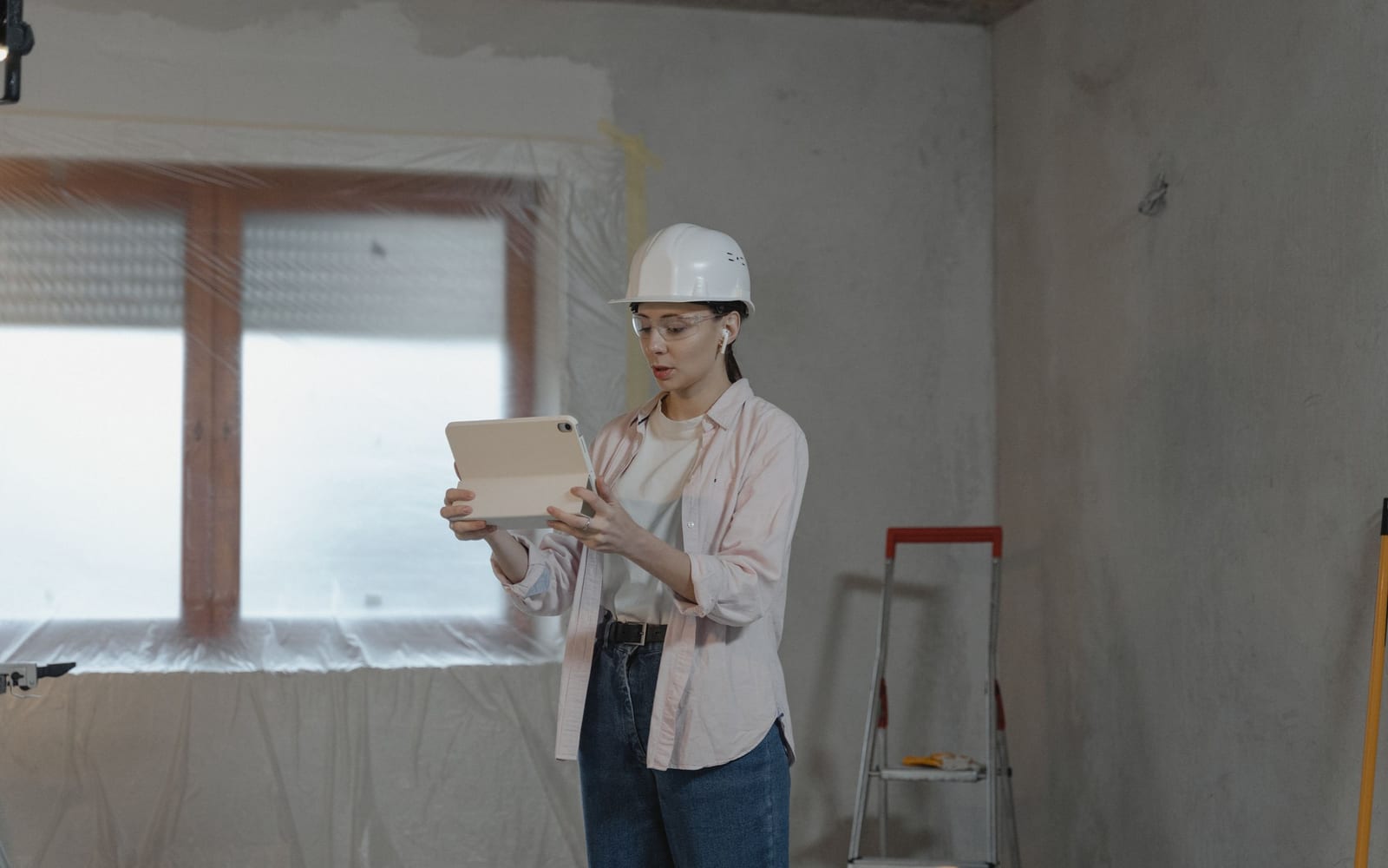 A technician using a tablet on a work site.