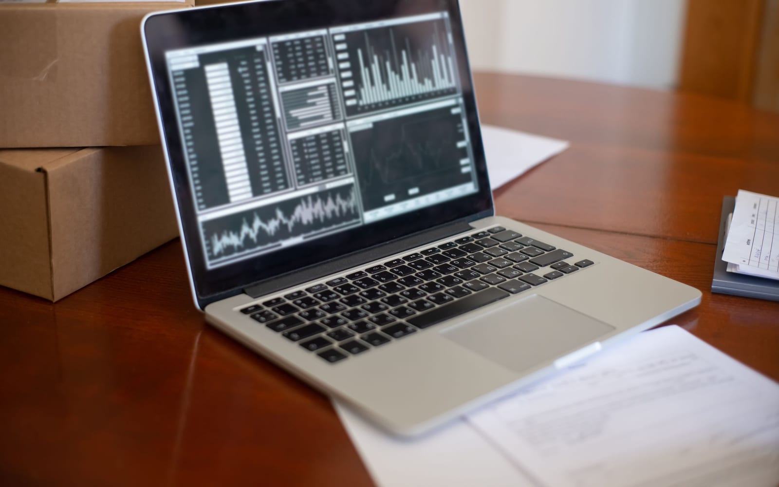 An analyst reviewing figures on a laptop in an office.