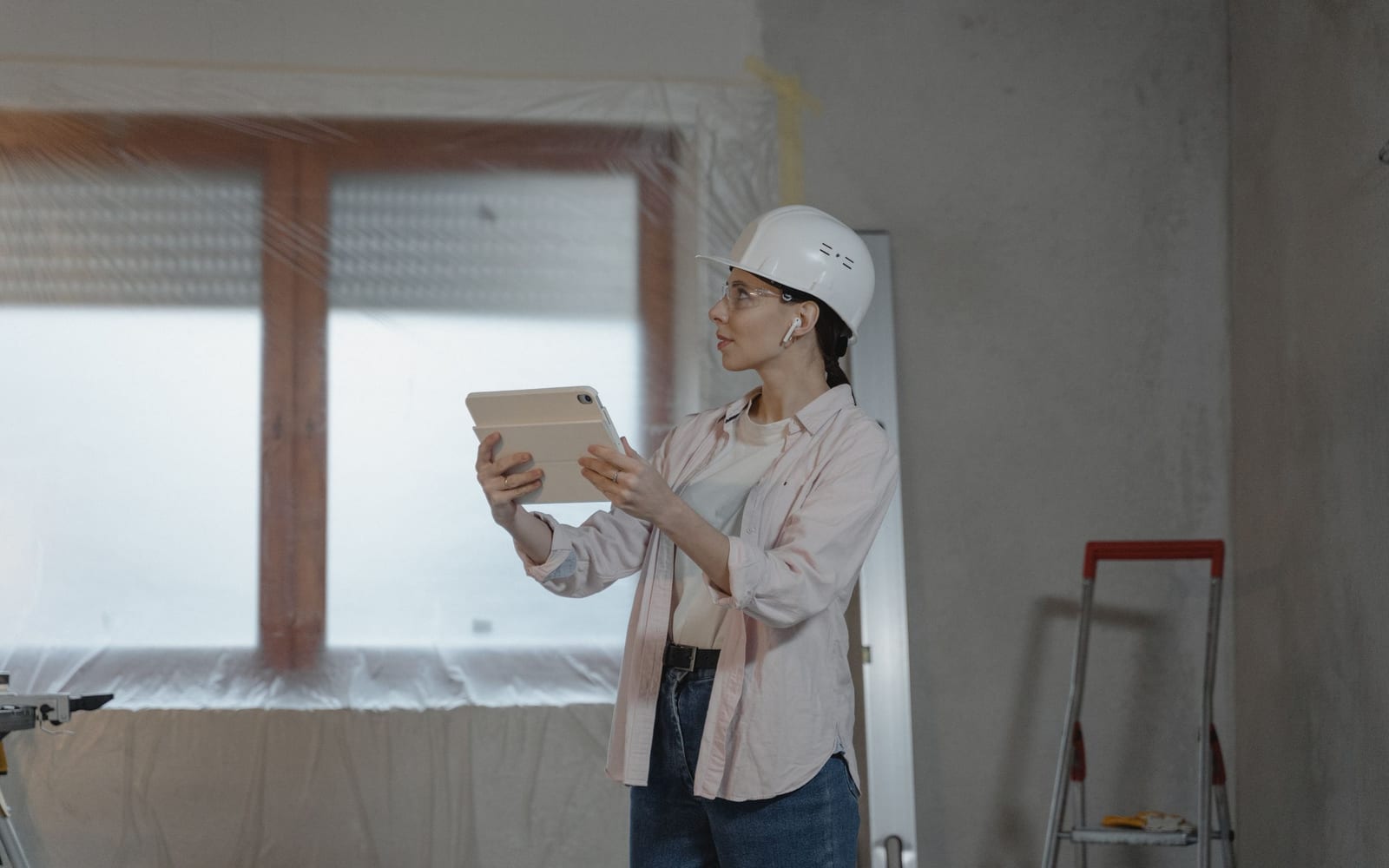 A technician using a tablet on a work site.