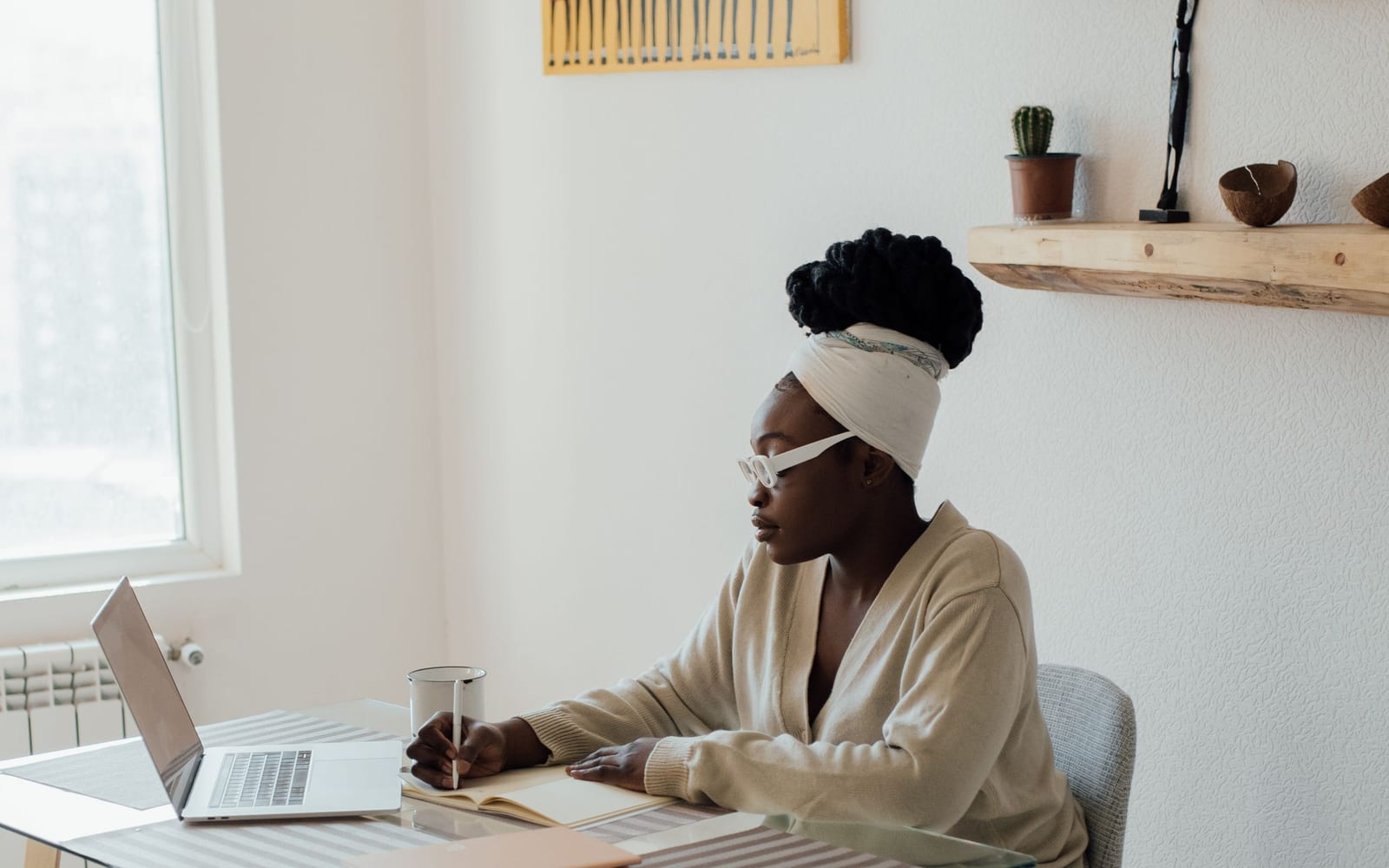 An analyst reviewing figures on a laptop in an office.