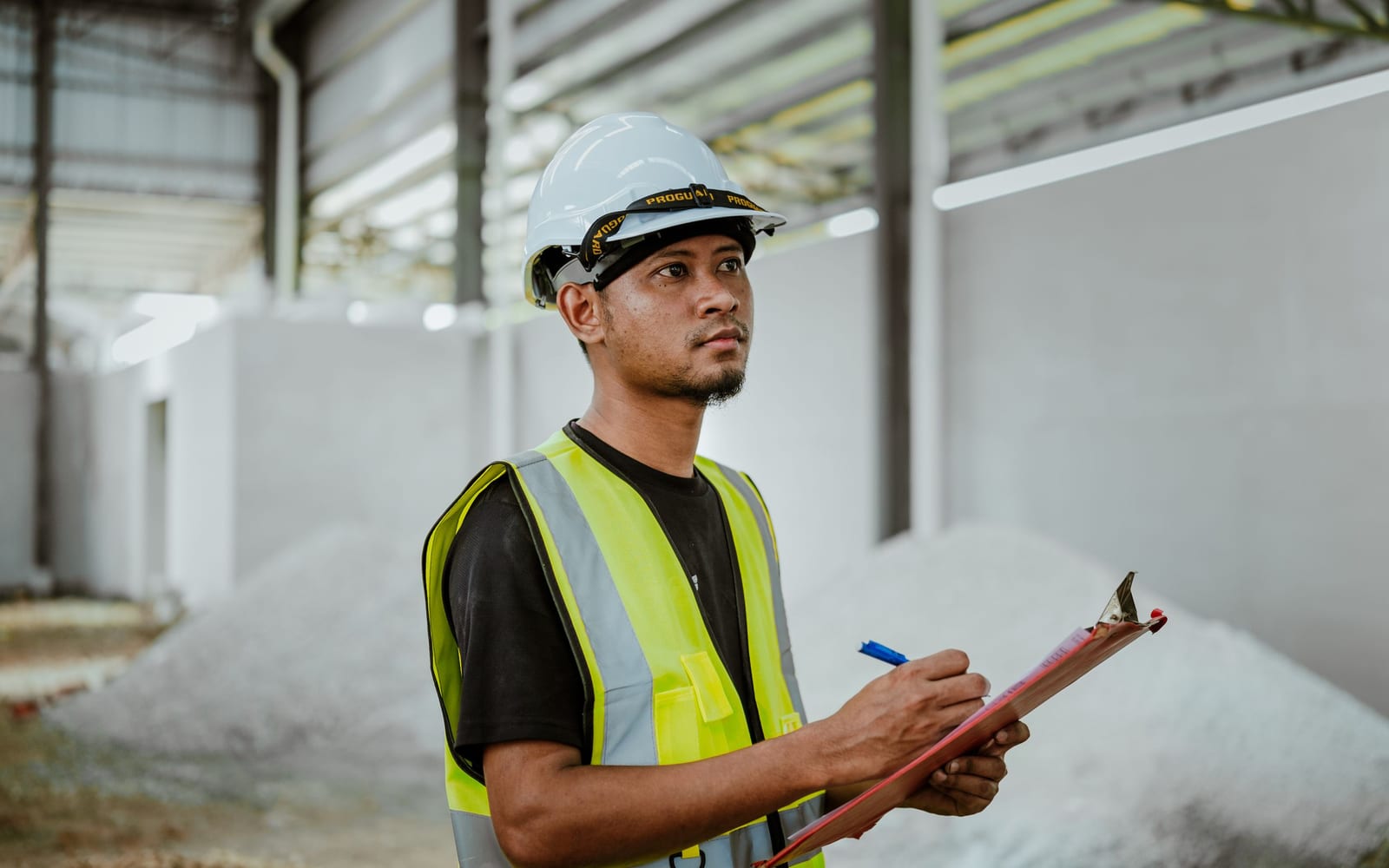 An engineer with a tablet on a factory floor.