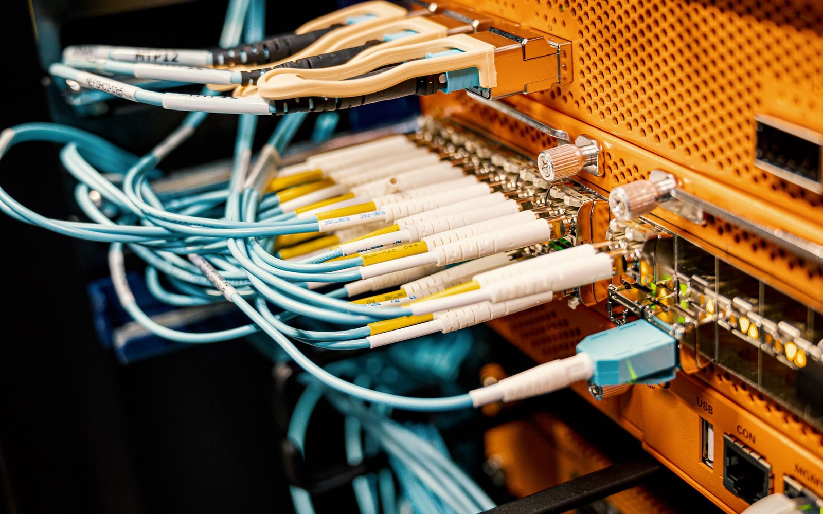 An engineer working beside servers in a data centre.