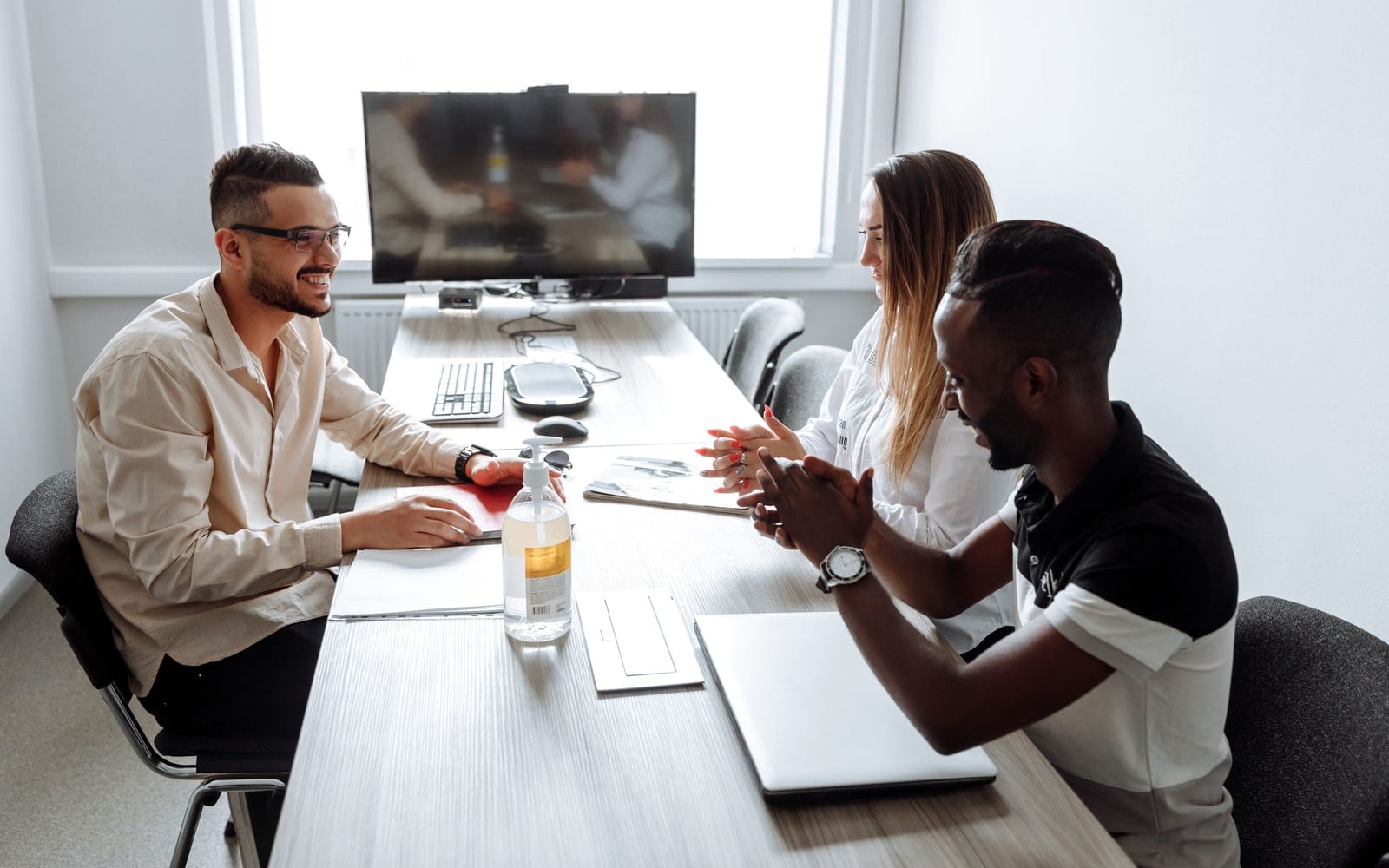 An enterprise meeting in a glass-walled conference room.