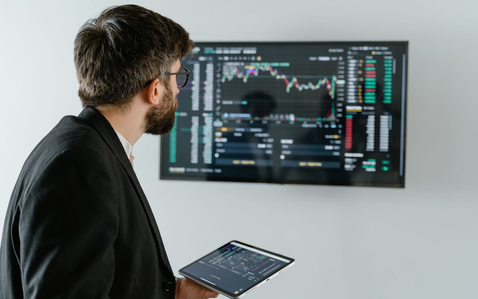 An analyst reviewing figures on a laptop in an office.