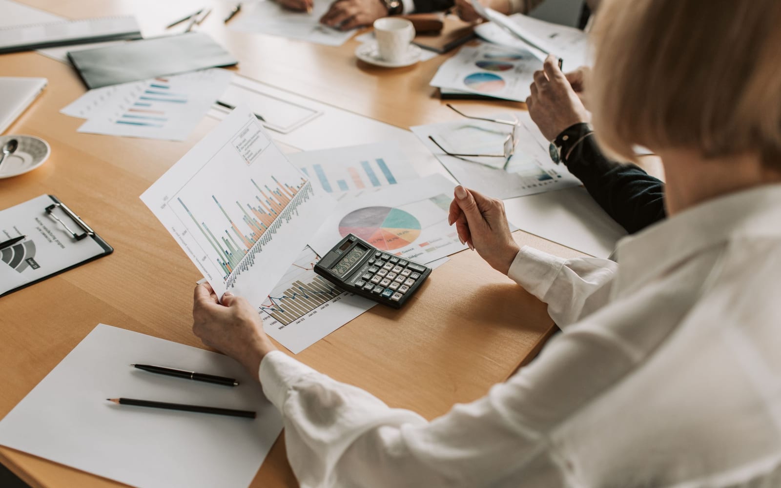 A finance meeting around a conference table.