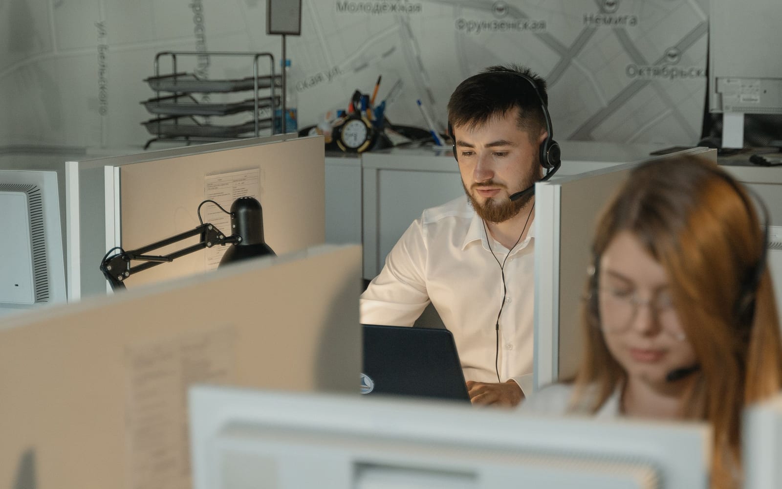 A service agent working with a headset in a contact centre.