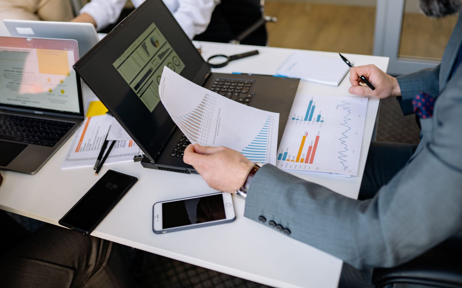 An analyst reviewing figures on a laptop in an office.