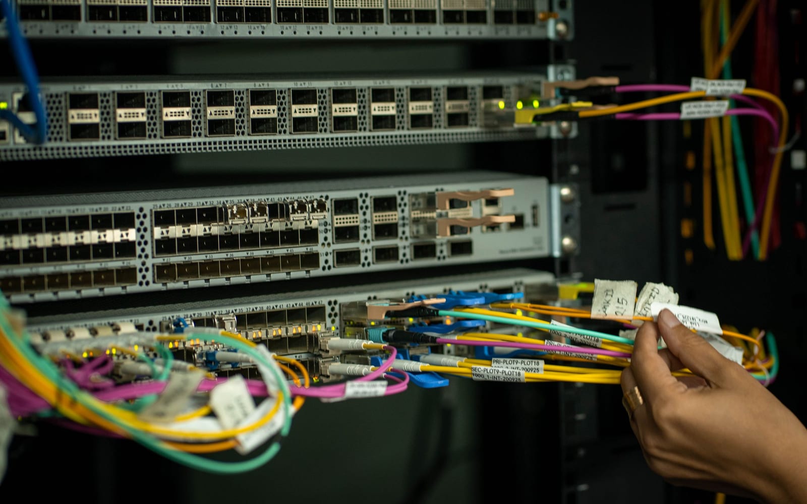 An engineer working beside servers in a data centre.