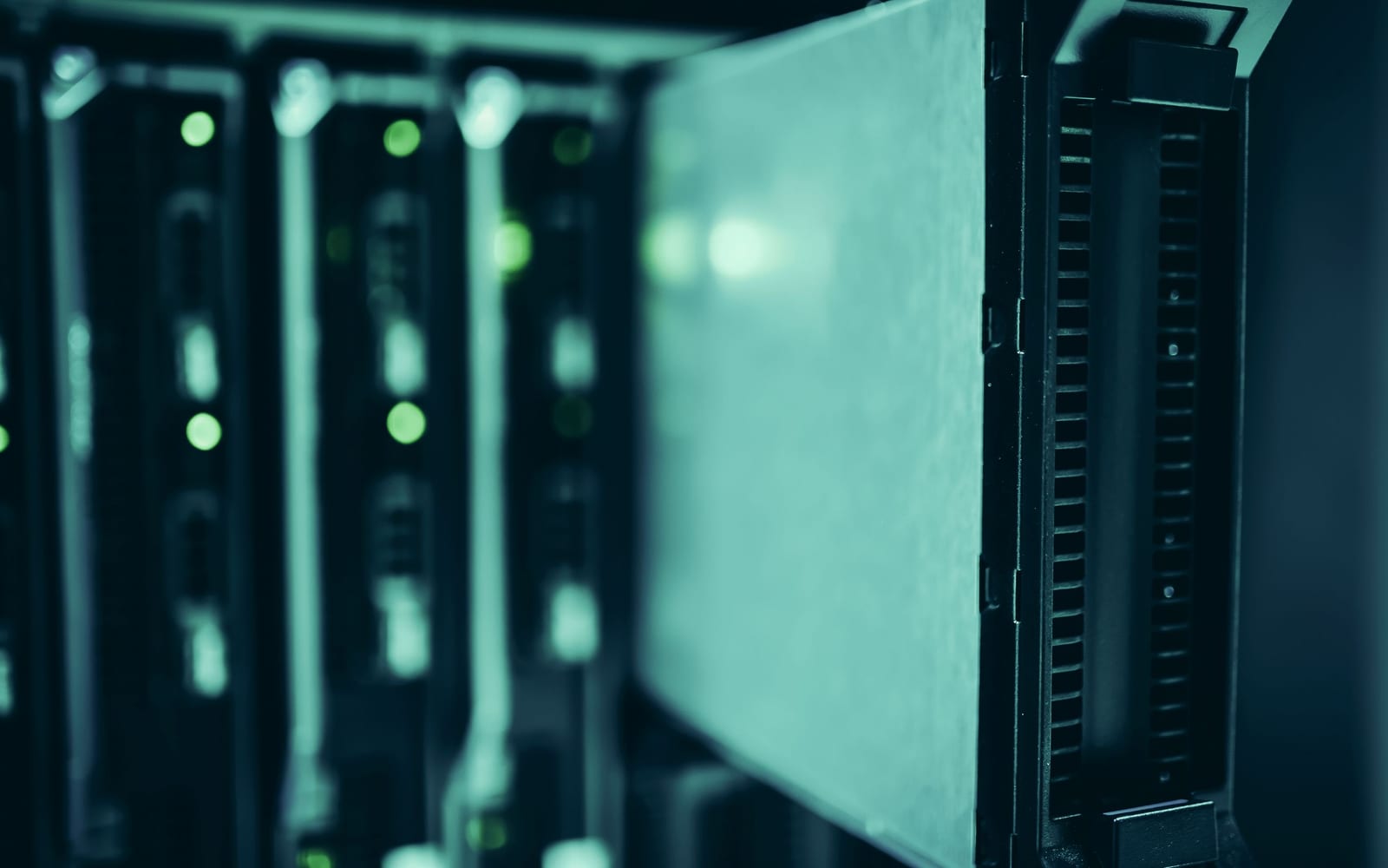 An engineer working beside servers in a data centre.