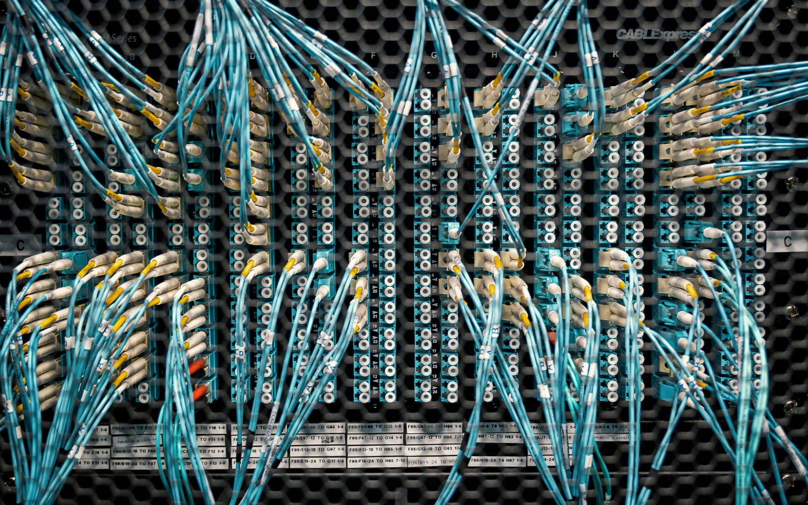 An engineer working beside servers in a data centre.