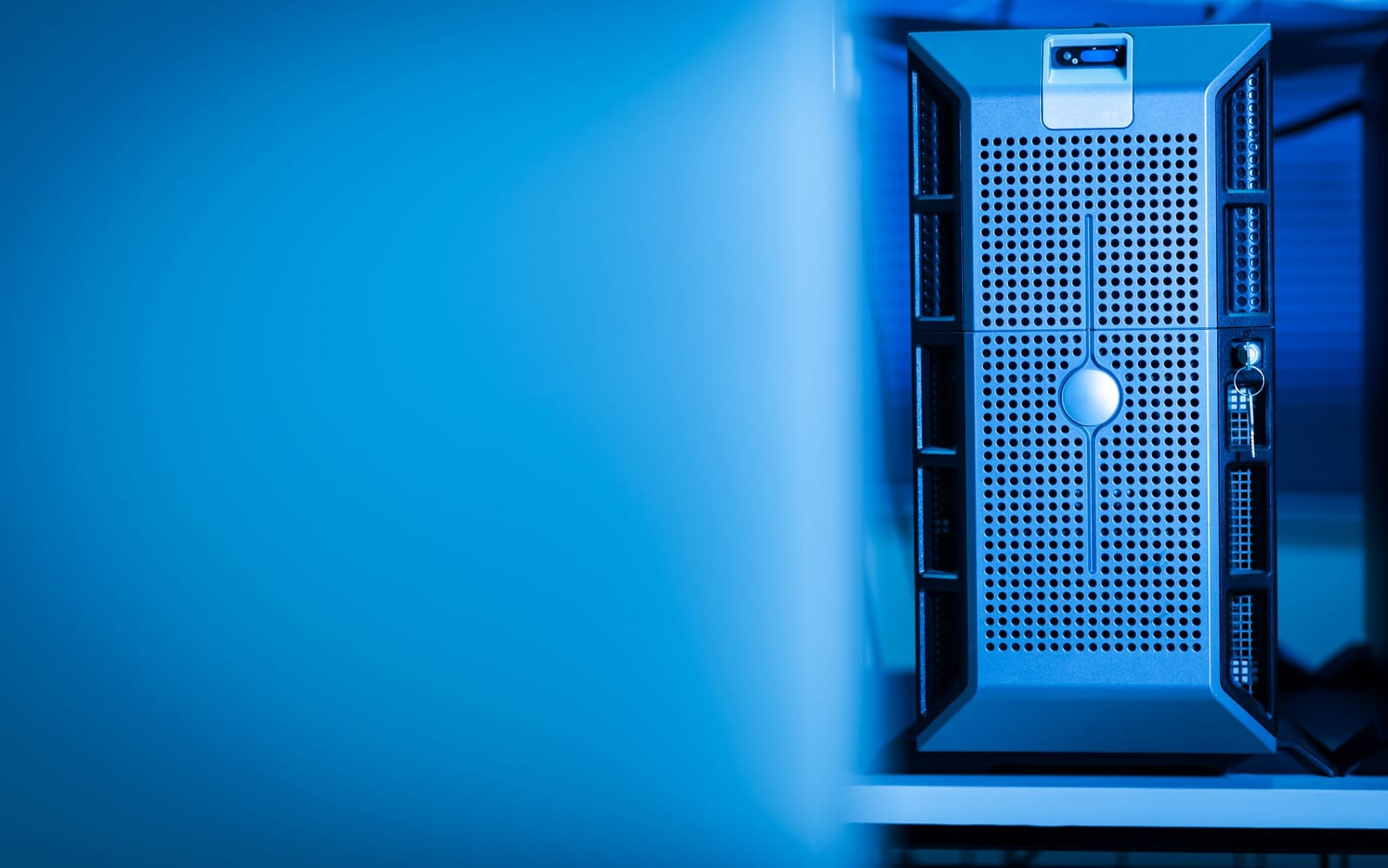 An engineer working beside servers in a data centre.