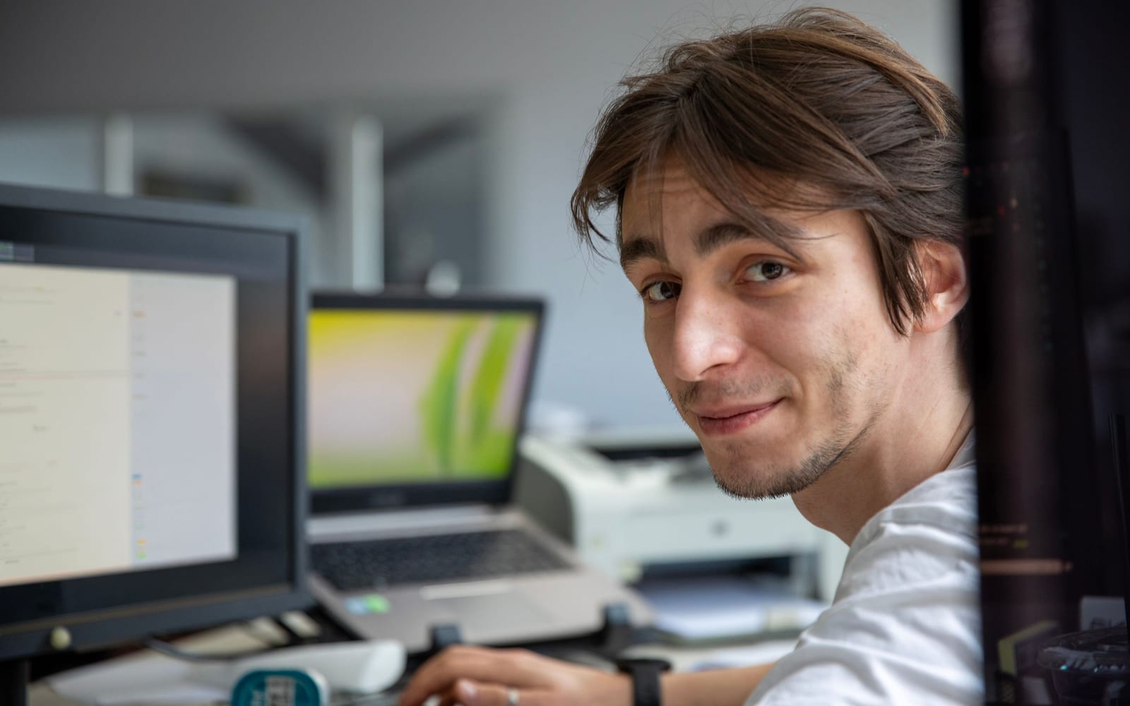 An engineer working beside servers in a data centre.
