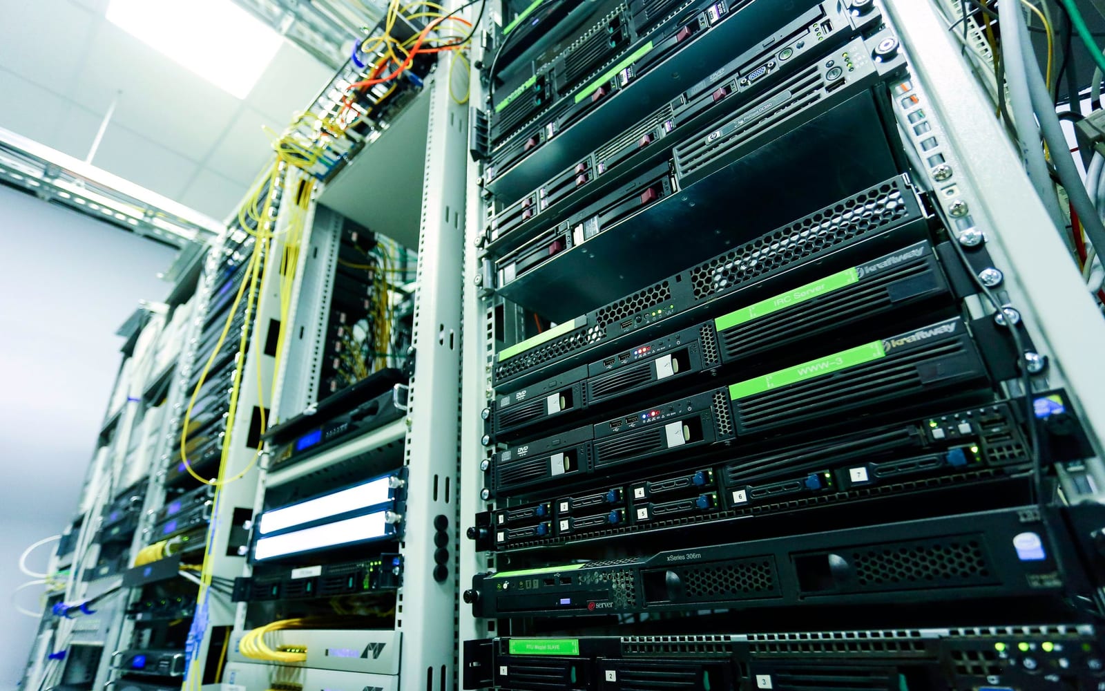 An engineer working beside servers in a data centre.